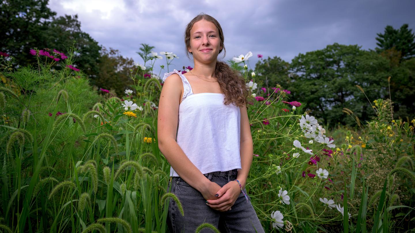 Bela Friedman in front of the wild flowers at the FFAC