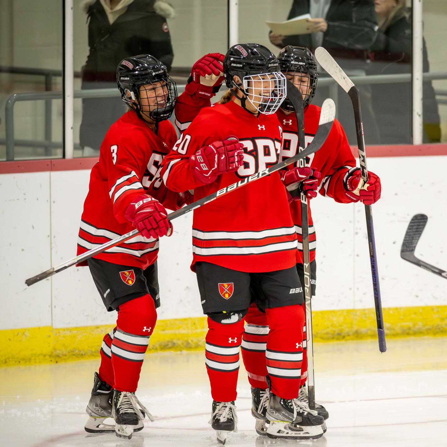 Chelsea congratulating her sister Cami after scoring a goal in hockey game