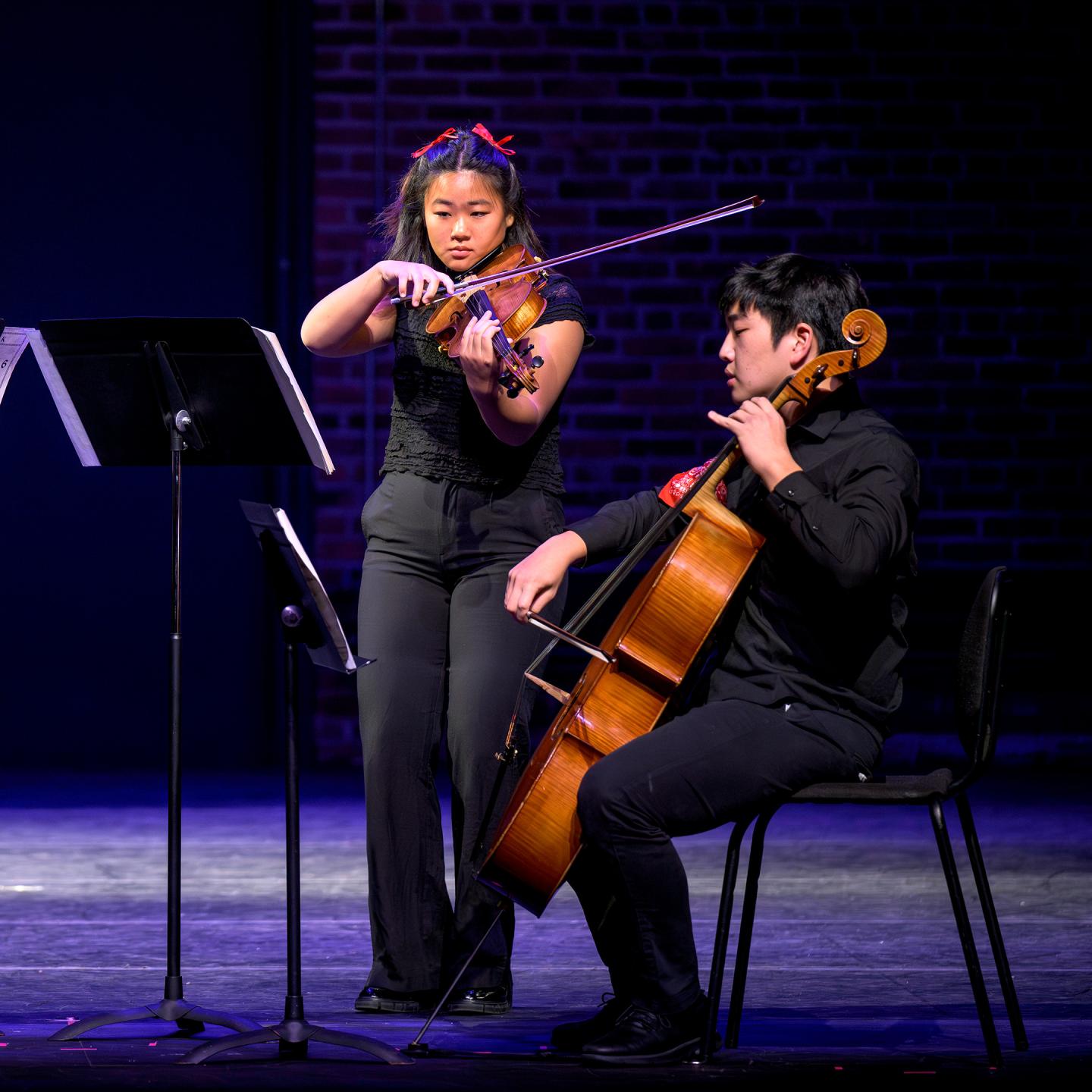 Hana and Ian play together during last fall's performing arts showcase during Family Weekend.
