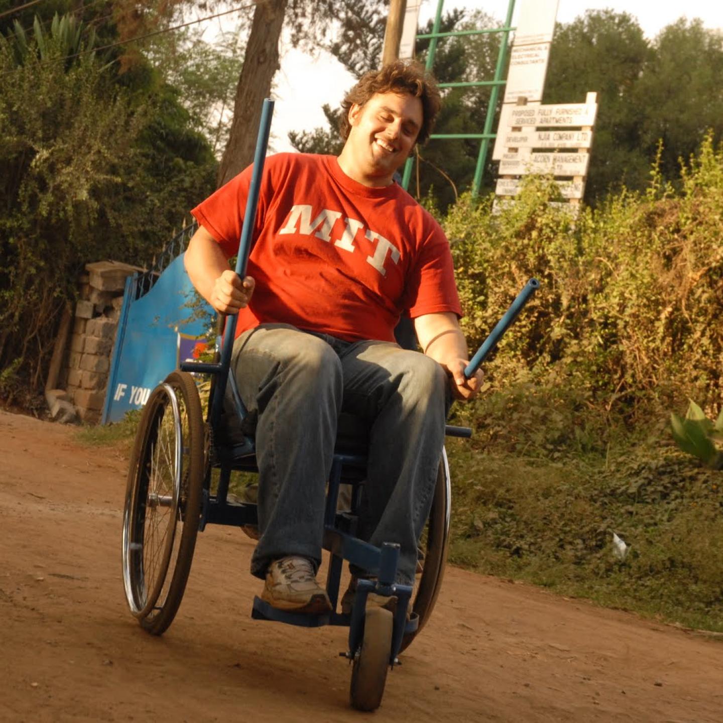 Amos Winter demonstrates the functionality of a new wheelchair he build during his studies.