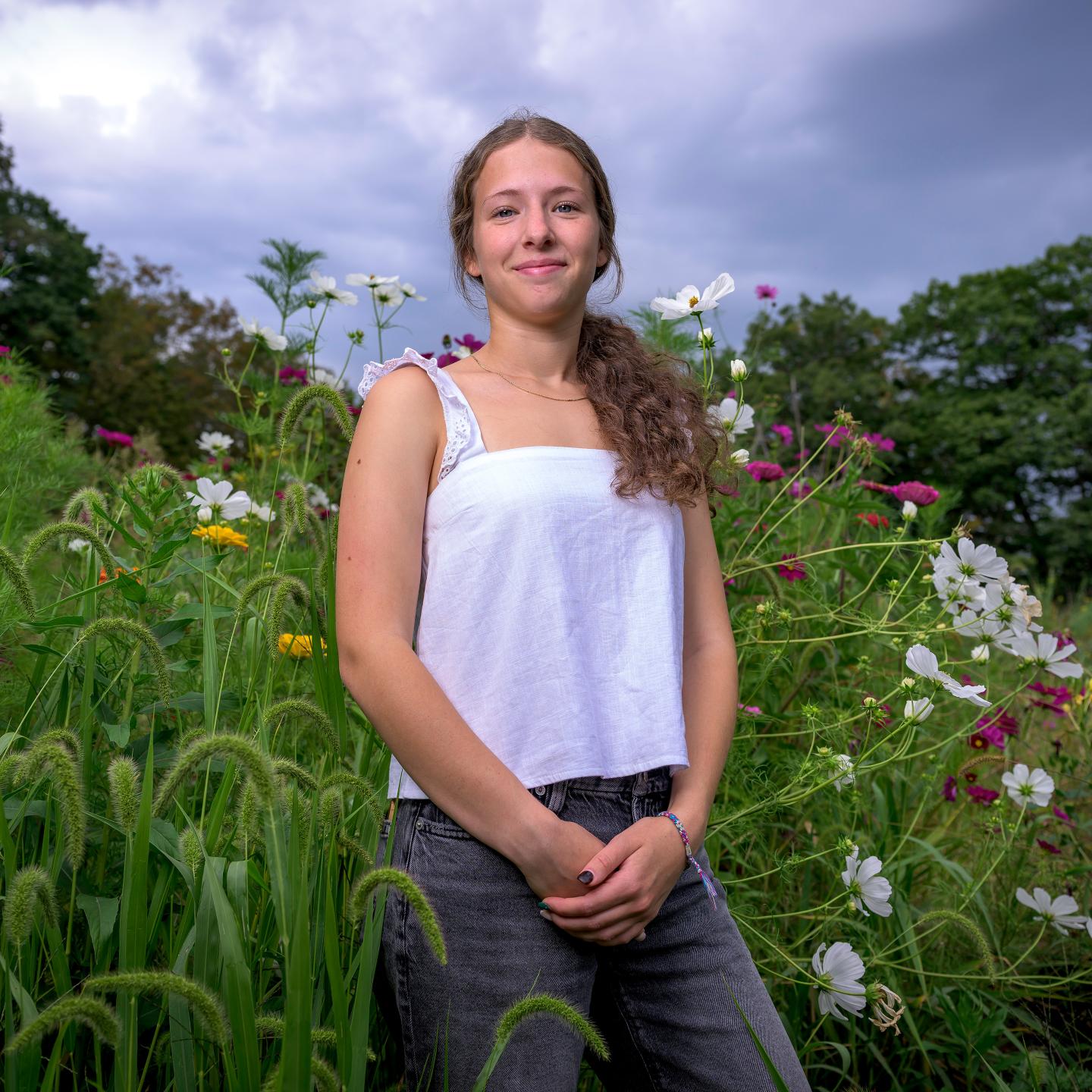 Bela Friedman in front of the wild flowers at the FFAC