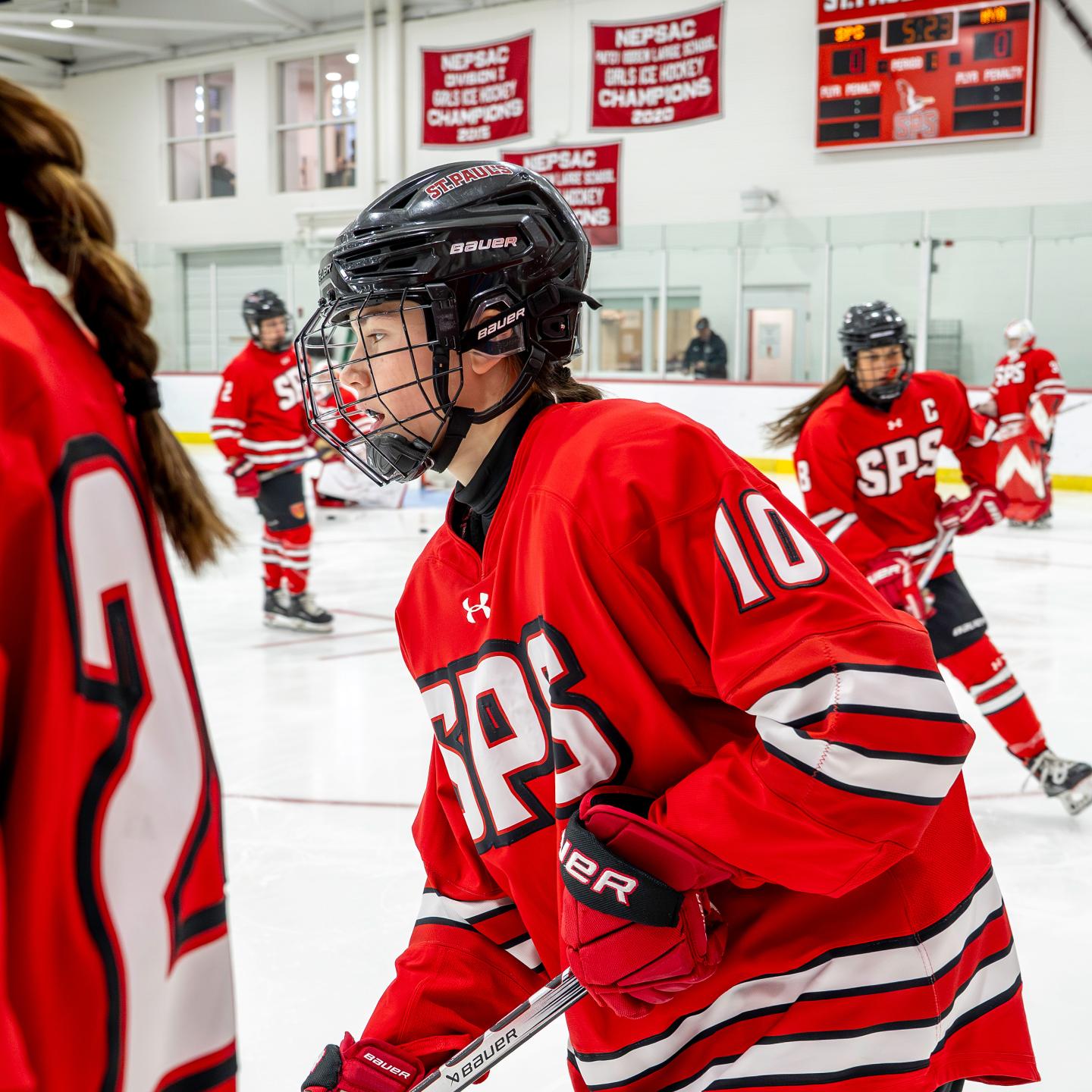 Iris '28 on the ice during warmups for girls hockey 