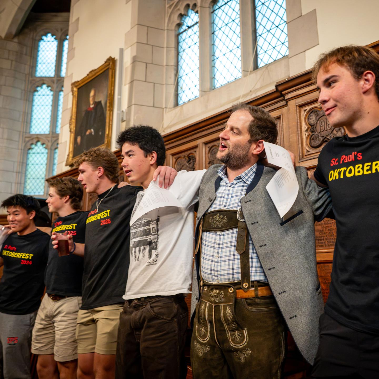 Justin Mohler and students singing during Oktoberfest celebration 2026