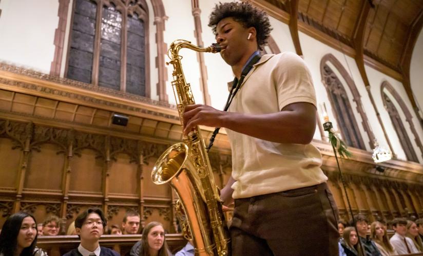 Hudson Stovall playing sax during Festival of Lights