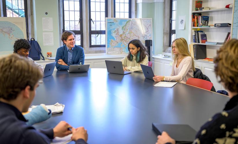 Humanities teacher and chaplain Rev. Sam Lovett leads a discussion in his Science, Philosophy and Religion class around the Harkness Table.