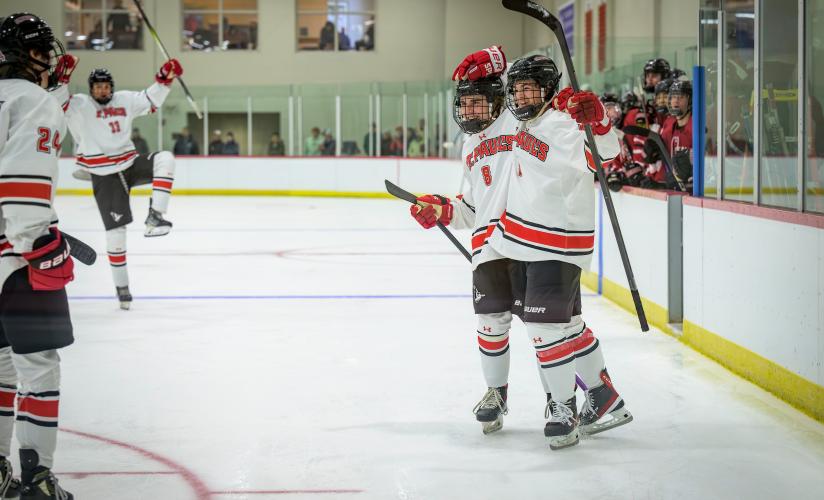 Boys Varsity Hockey players celebrate a goal in their game against Groton on Nov. 27, 2023.