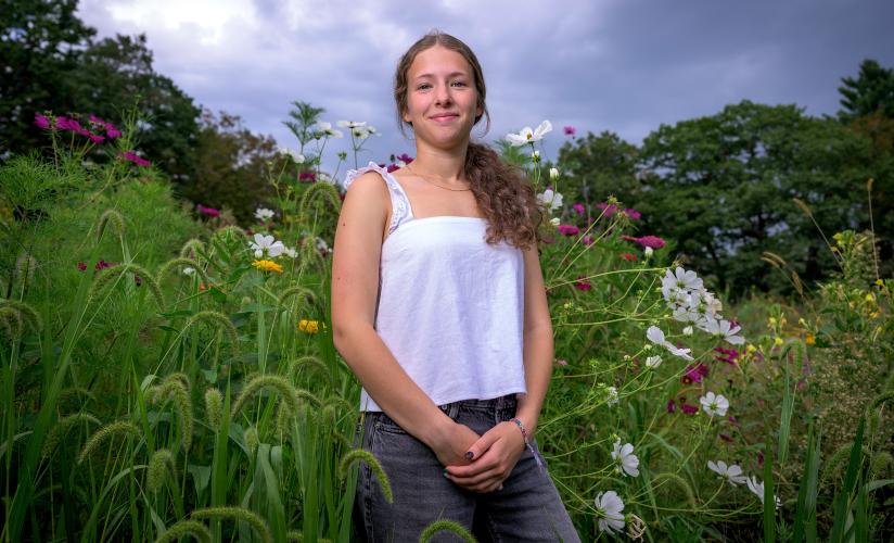 Bela Friedman in front of the wild flowers at the FFAC