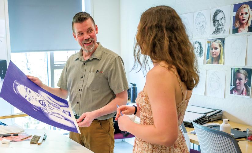 Brian Schroyer with one of his students in drawing class.