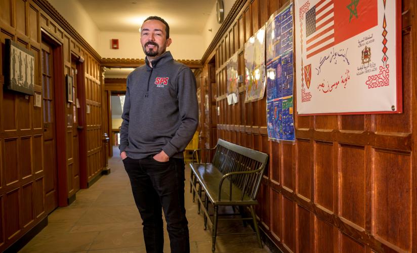 Environmental portrait of Zayer Baazaoui in the hallway of the Schoolhouse