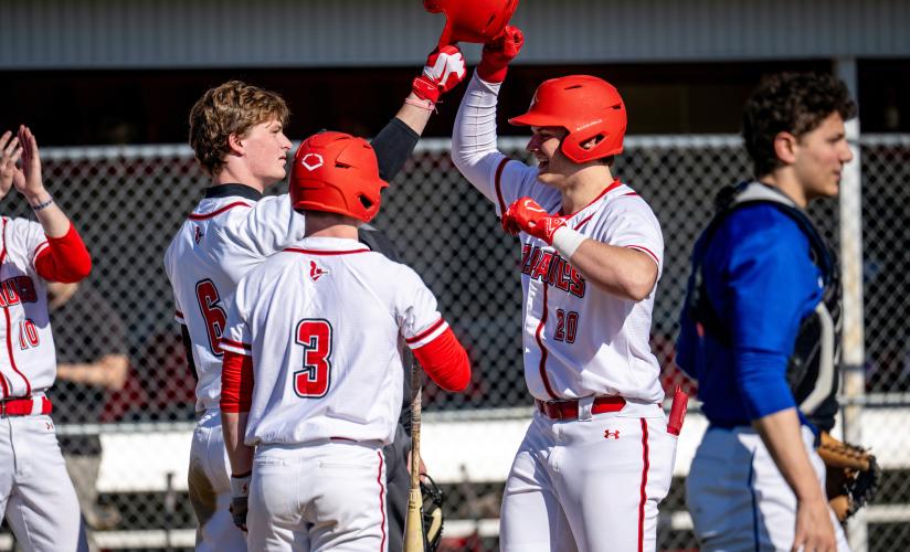 Boys varsity baseball celebrate a home run during a home game at St. Paul's School.
