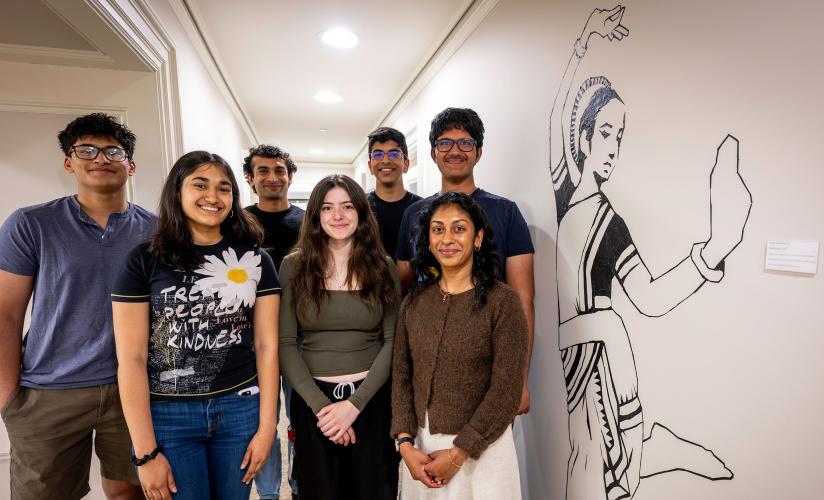 Pankti Dalal with students in front of the mural