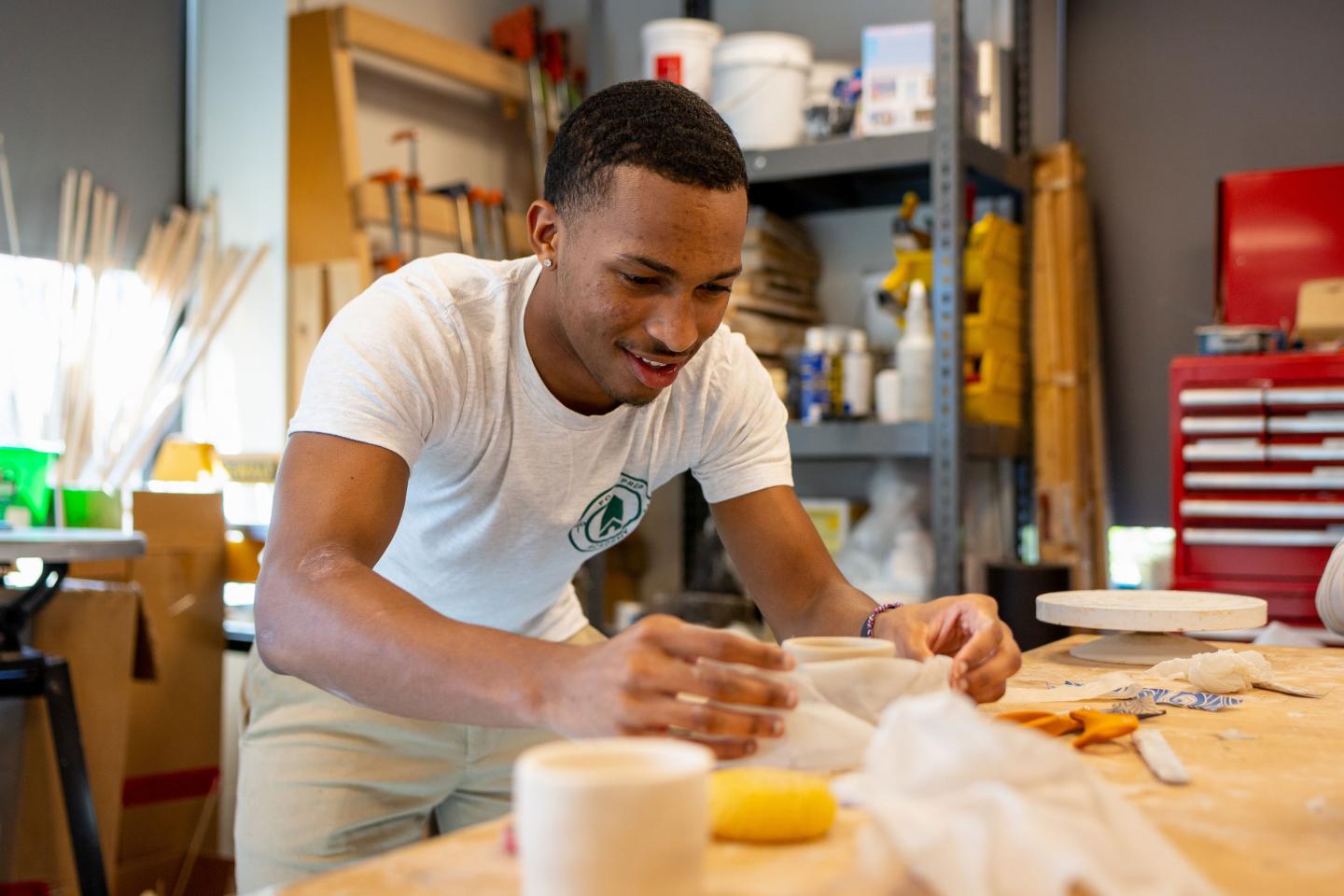 student in ceramics class. 