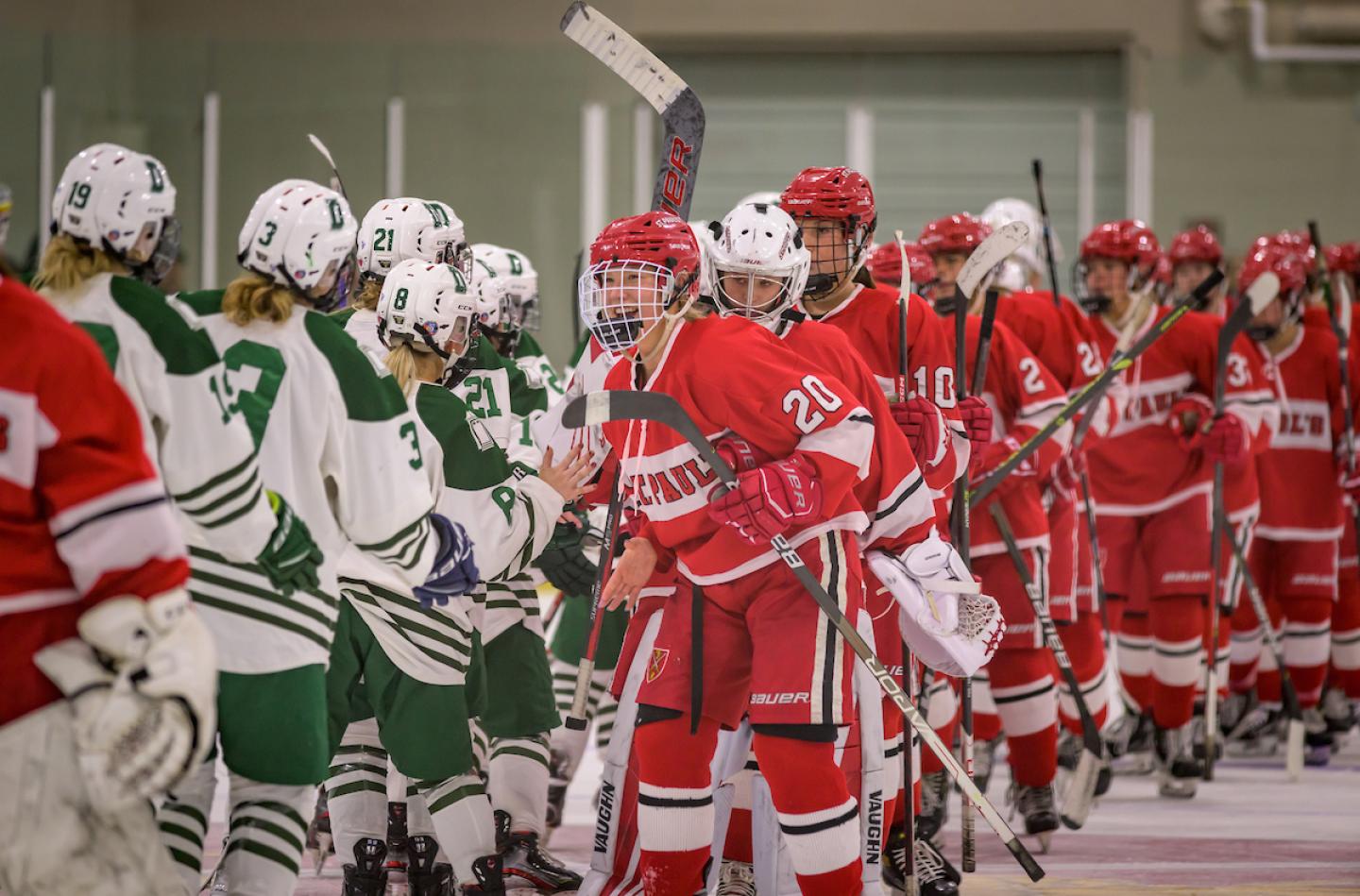 St. Paul's School Girls Varsity Hockey shake hands with opponents after a win.