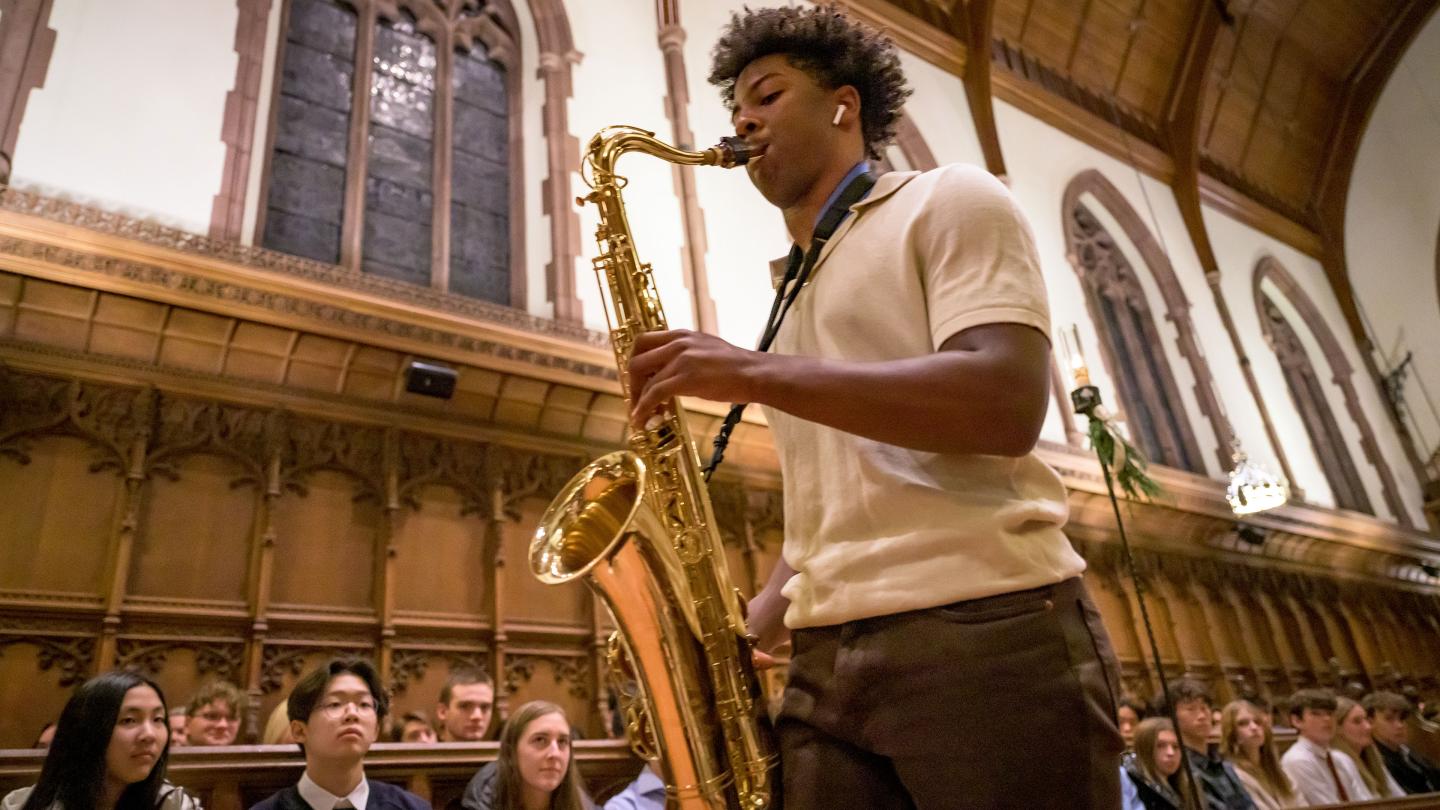 Hudson Stovall playing sax during Festival of Lights