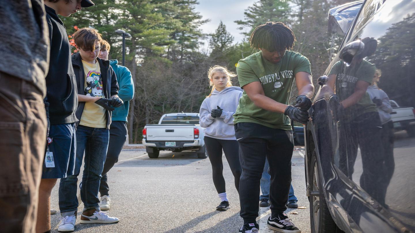 Students learned to replace a car tire during LinC Day.