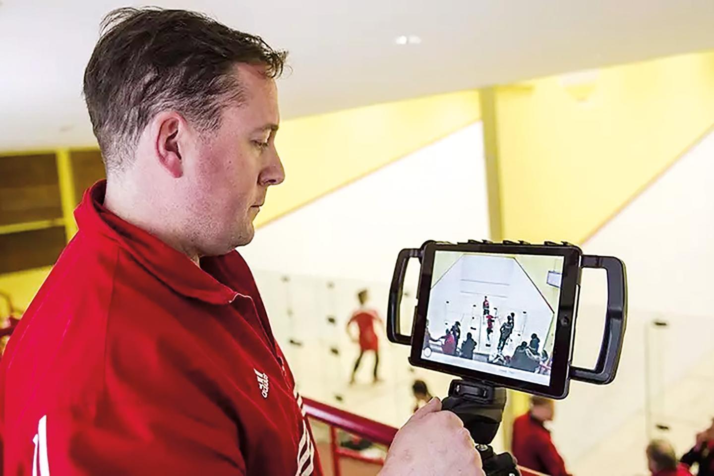 Chris Smith monitoring multiple matches at the McLane Squash Courts