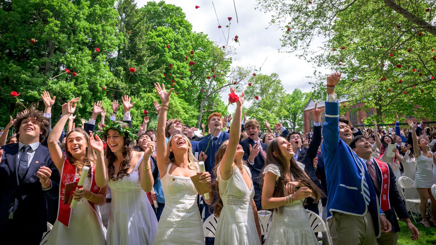 Graduates throw roses at the end of the Graduation Ceremony for the Form of 2025