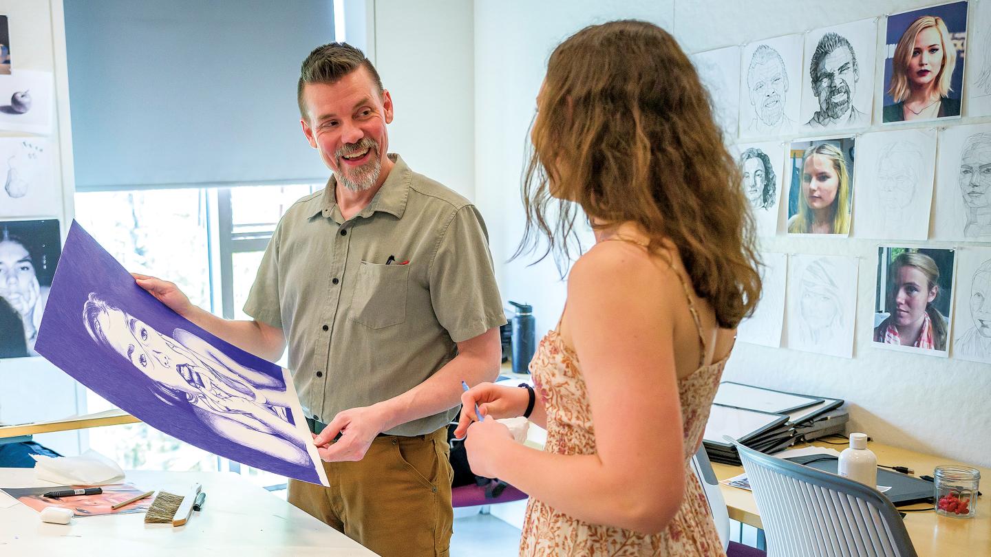 Brian Schroyer with one of his students in drawing class.