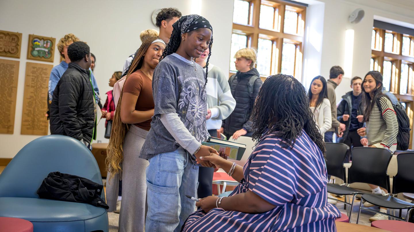 Renée Watson signing student copies of her book