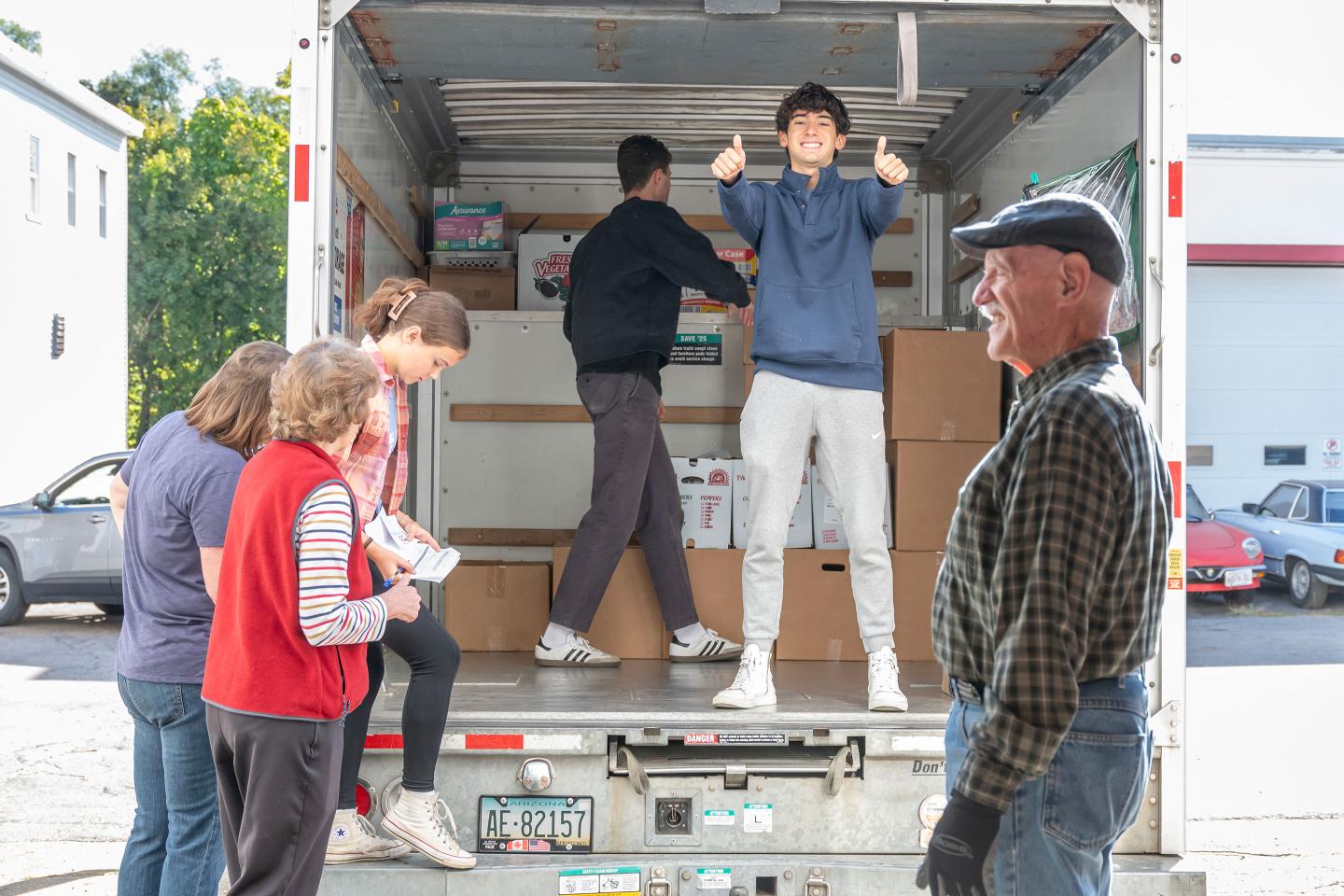 Students loading trucks for Christ the King food pantry