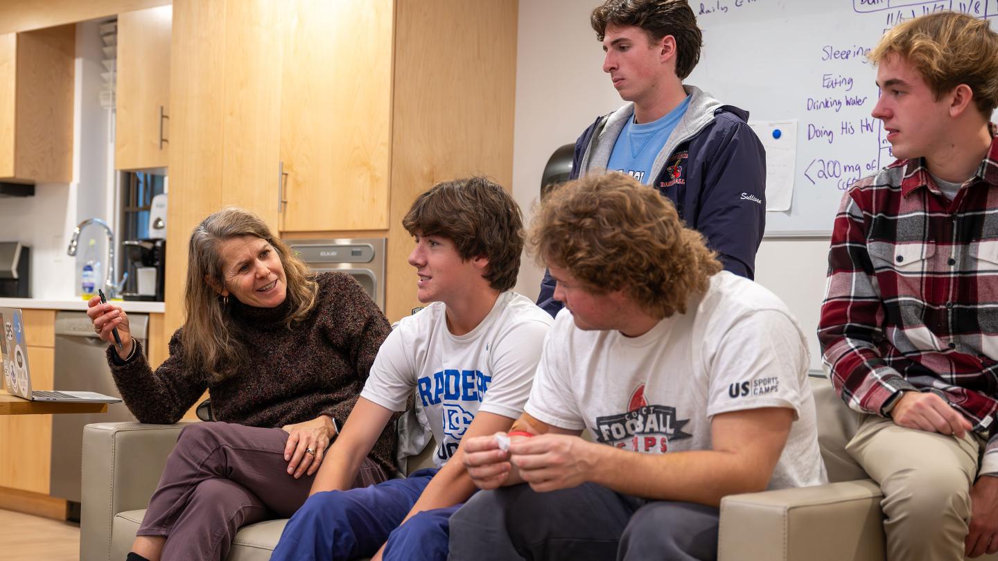 Kate Daniels talking with students in her dorm