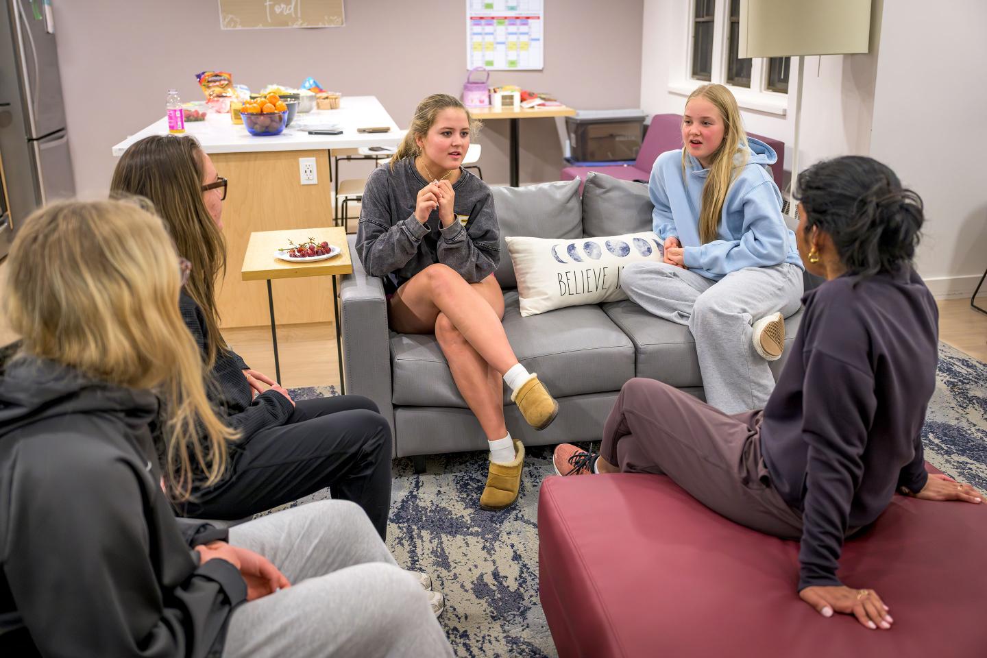 Students hanging out in common room with faculty advisers