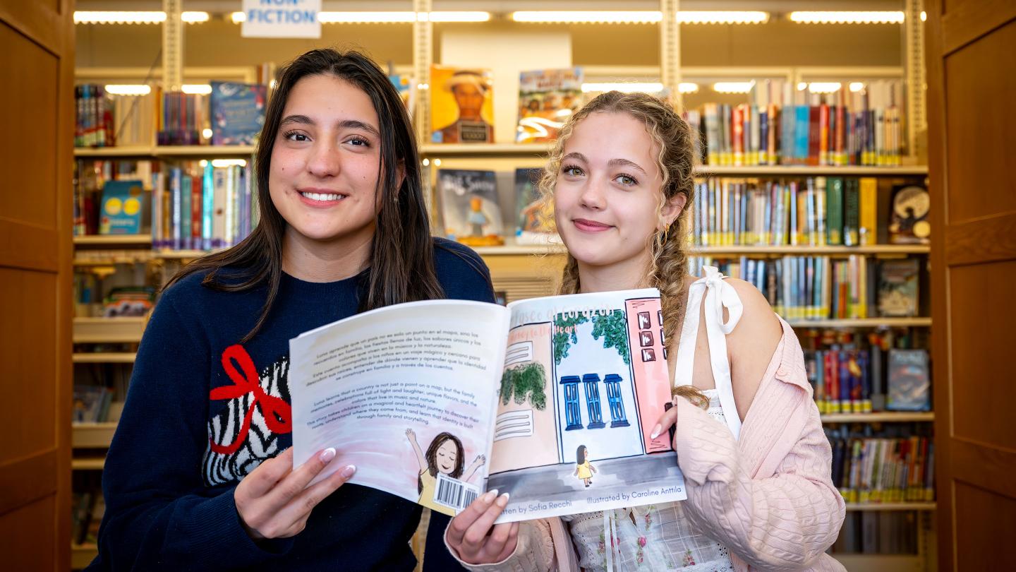 Sofia Recchi and Caroline Anttila holding their book