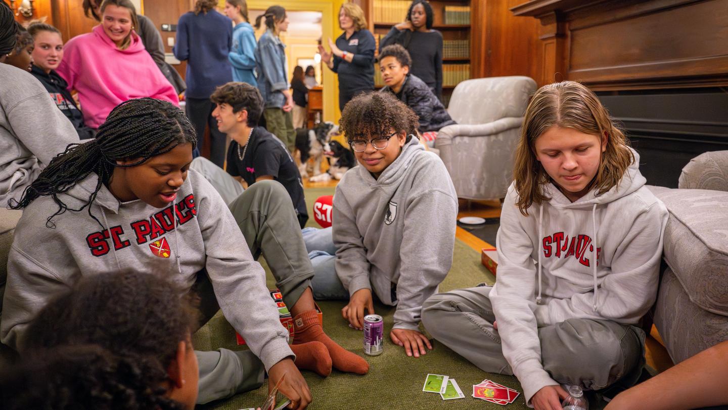 Students playing cards during Rectory Open House