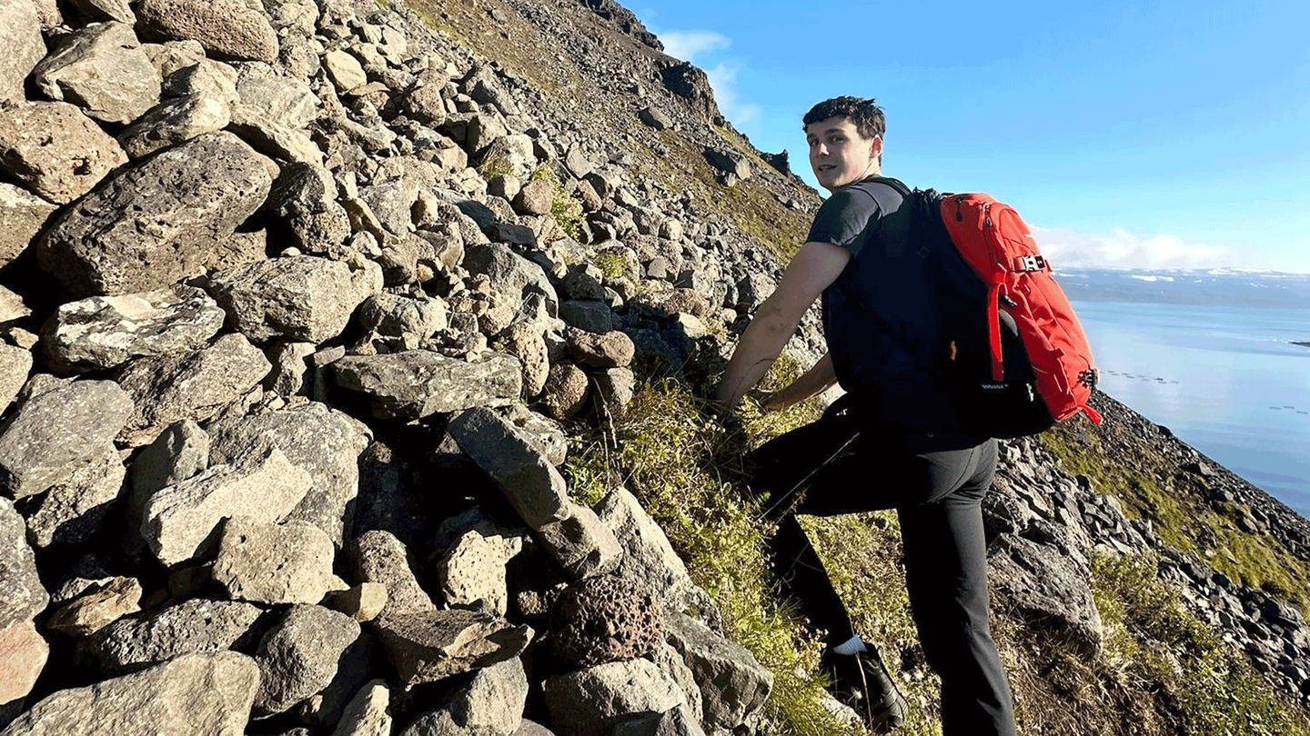 Kyle Pellerin hiking up a fjord in Isafjordur, Iceland