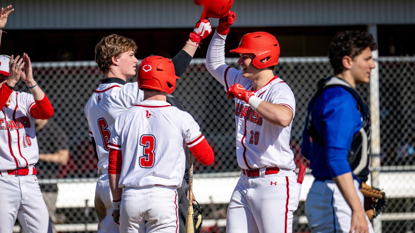 Boys varsity baseball celebrate a home run during a home game at St. Paul's School.