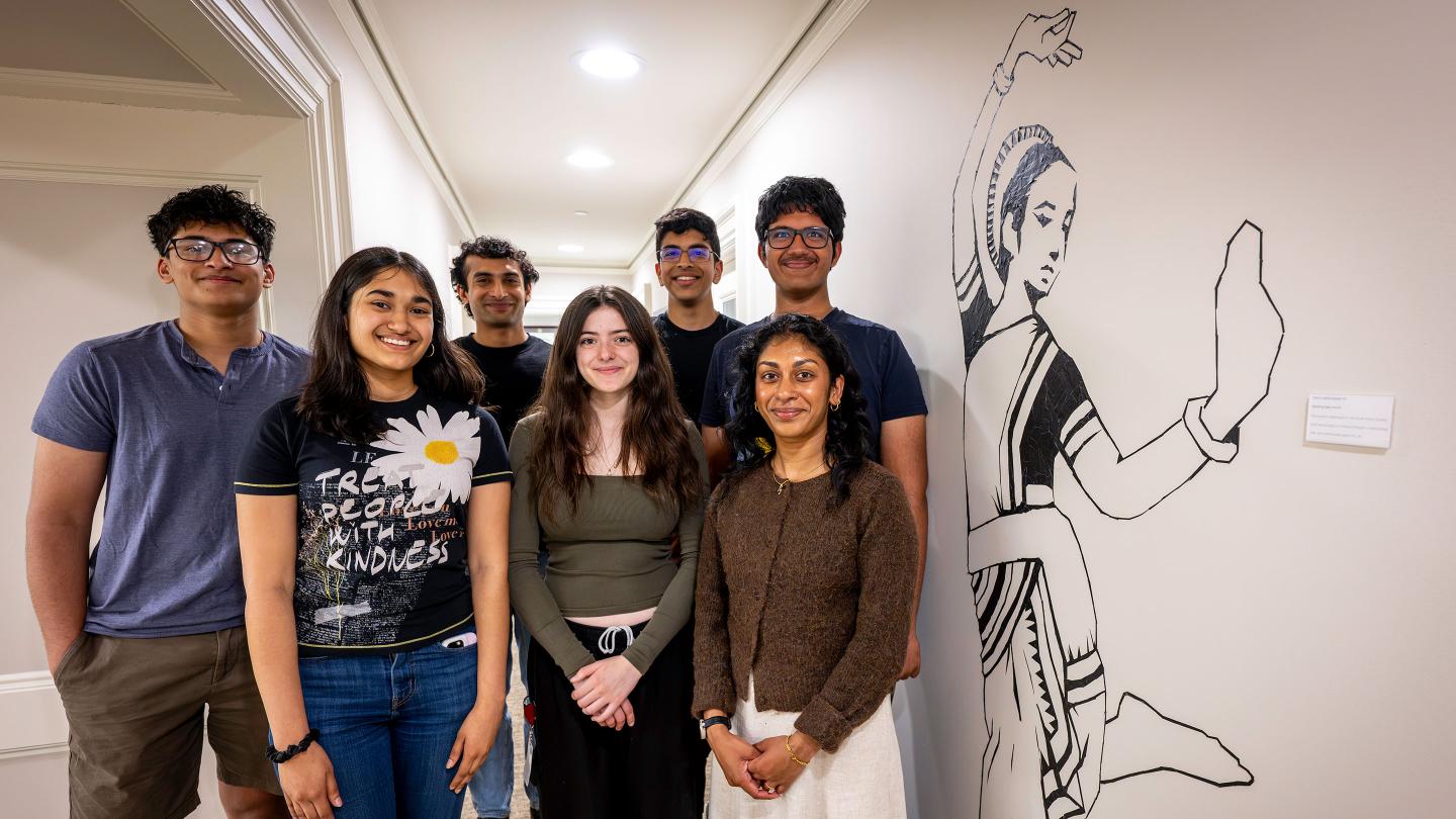 Pankti Dalal with students in front of the mural