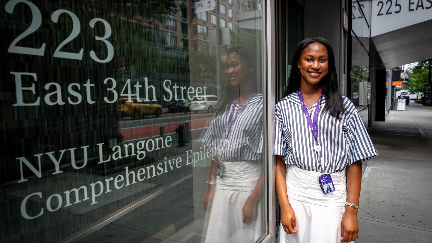 Motunrayo Odukoya ’27 stands outside the NYU Langone Comprehensive Epilepsy Center.